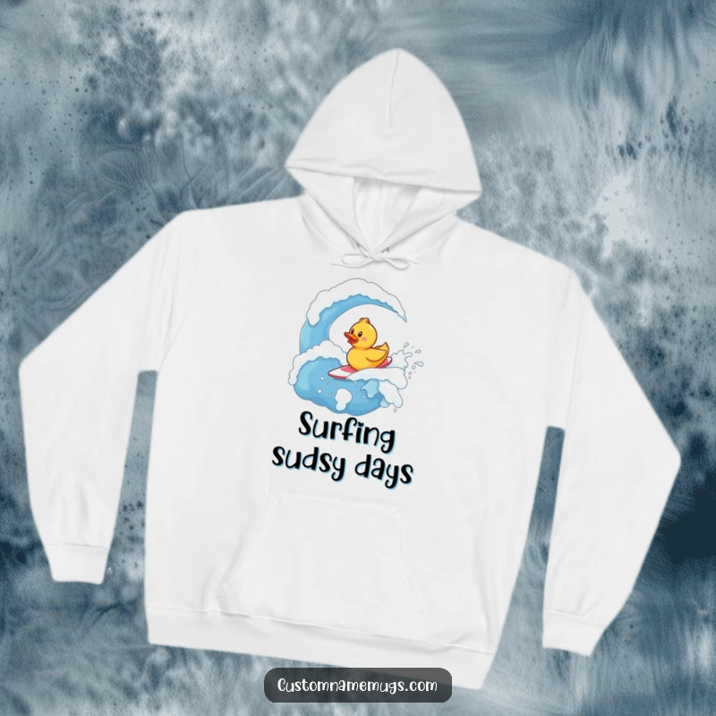 Funny Hoodie: Tiny, determined rubber ducky character bravely surfing a huge, bubbly soap wave, looking triumphant.